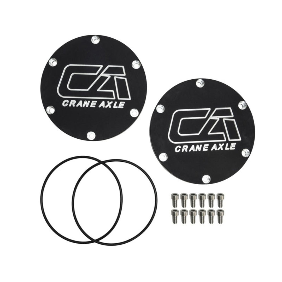 Two black Crane Axle 2005+ Super Duty unit bearing covers on a white background