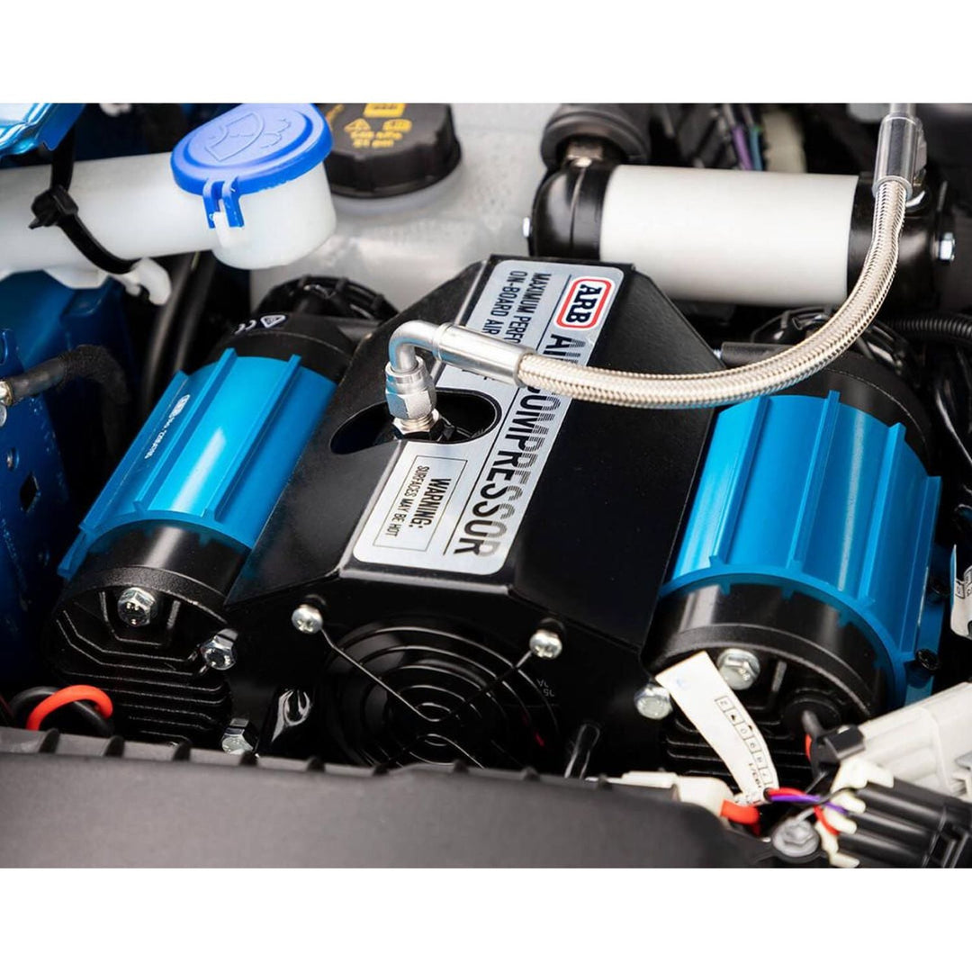 Close-up of the best compressor for air lockers and tire inflation with blue and black components in use.