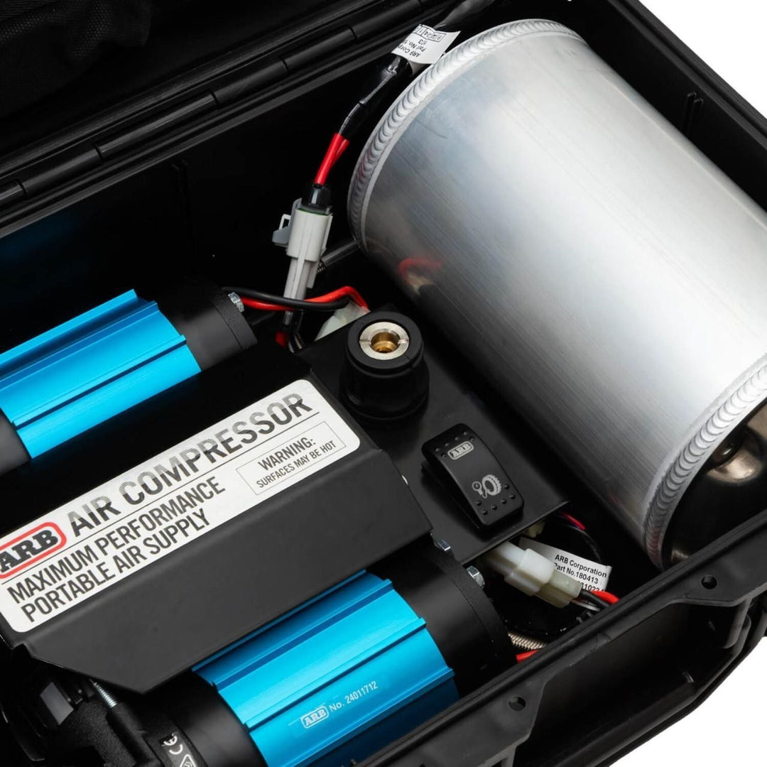Close-up of a portable ARB twin compressor for large tires with visible branding and components.