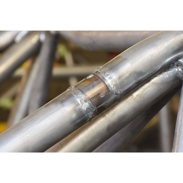 Close-up of a metal chassis with a 1.5
chromoly tube disconnect on a blurred background
